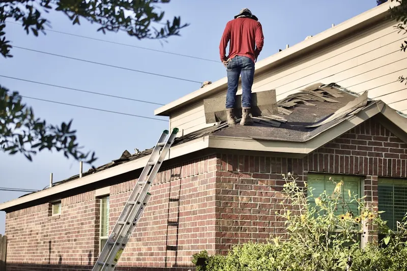 Professional roofer working on a residential roof in Eastern Shores
